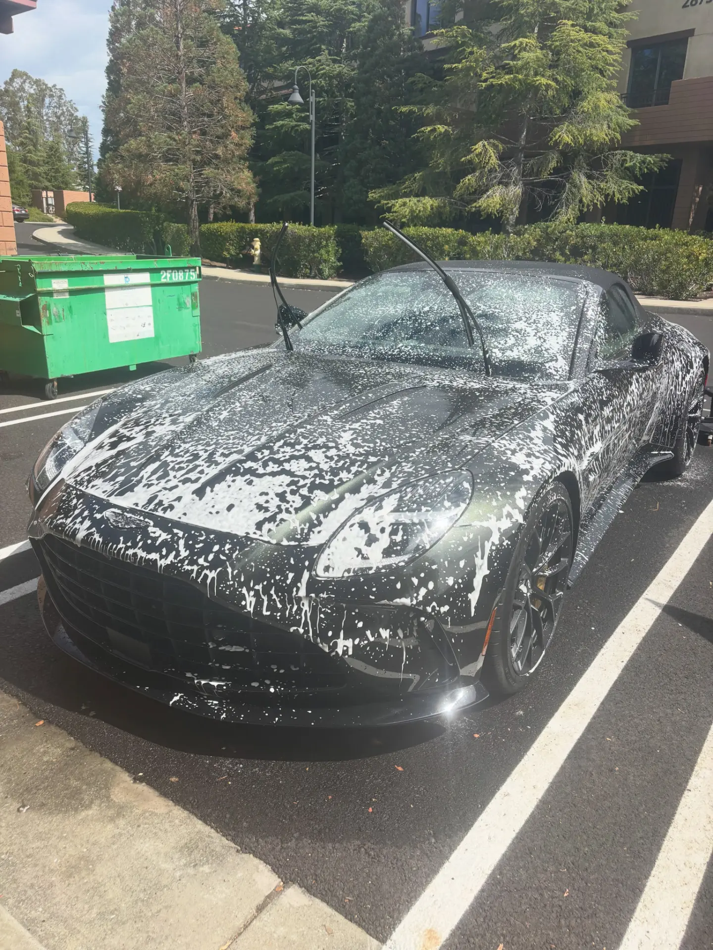 Aston Martin Vantage Roadster covered in foam during a premium detail