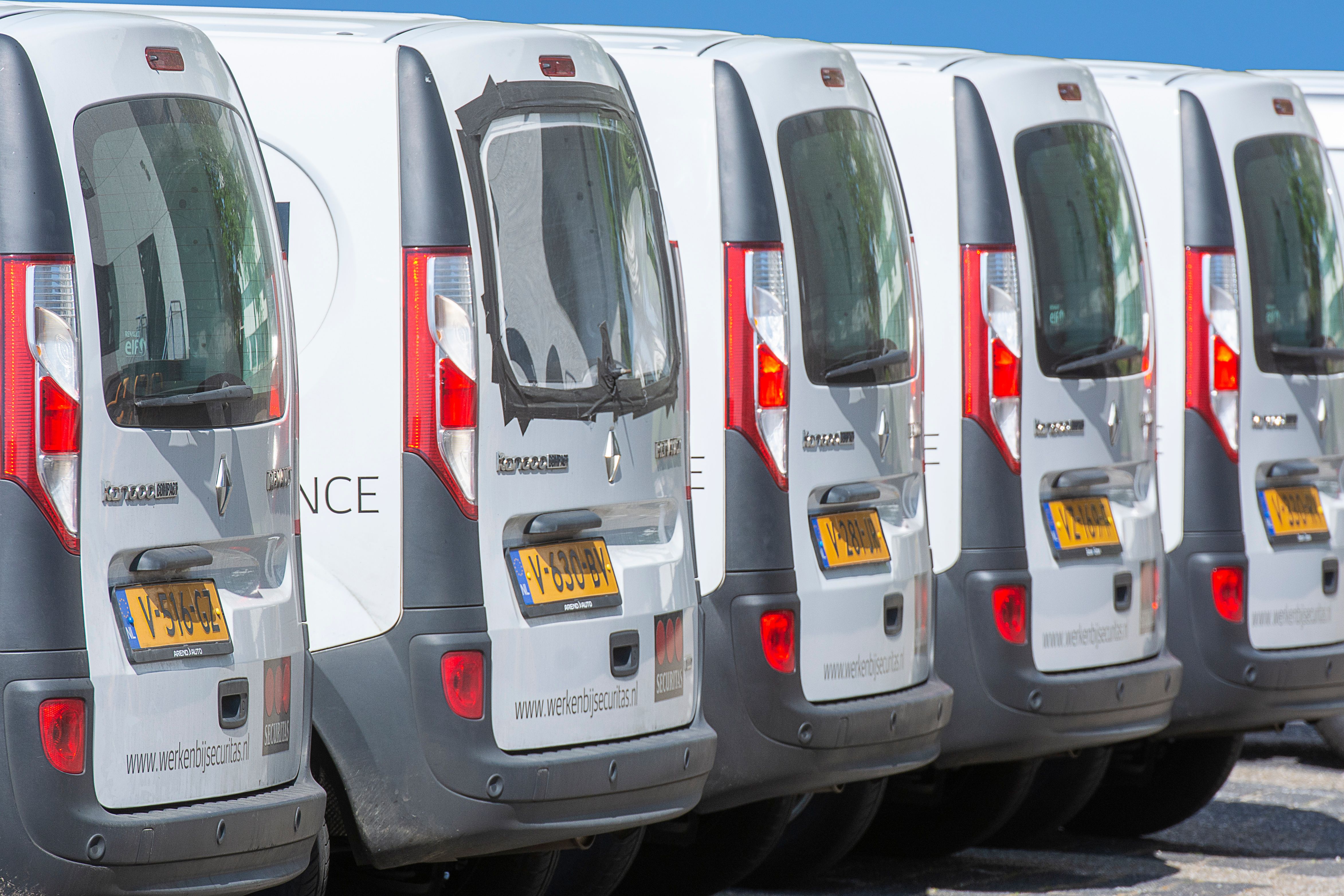 Uniform commercial vans lined up for a fleet maintenance program