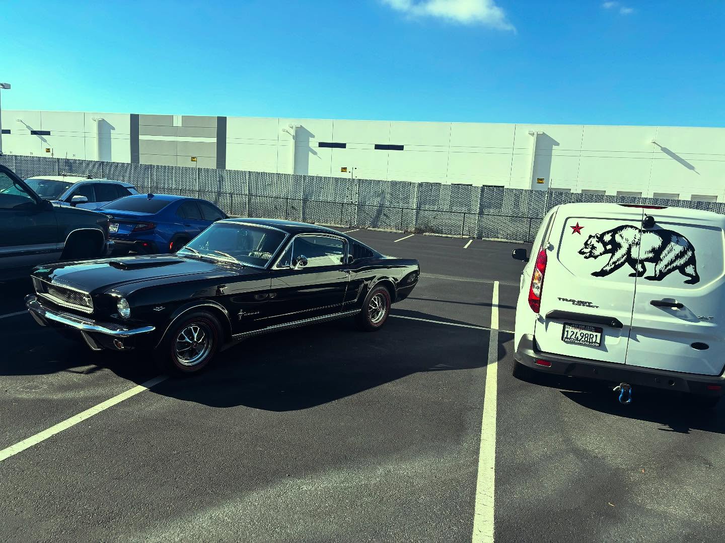 WMD Detailing van beside a classic Mustang in San Francisco