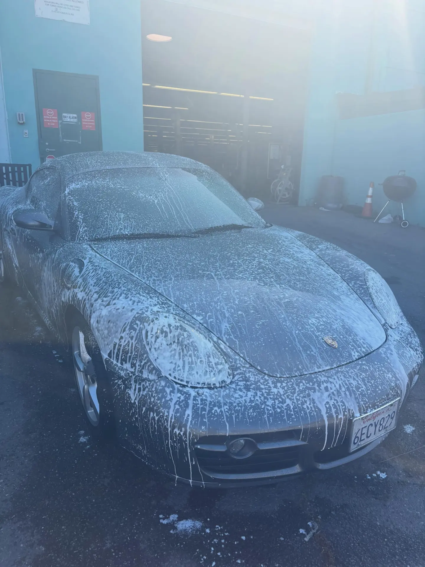Porsche Cayman covered in foam before detailing